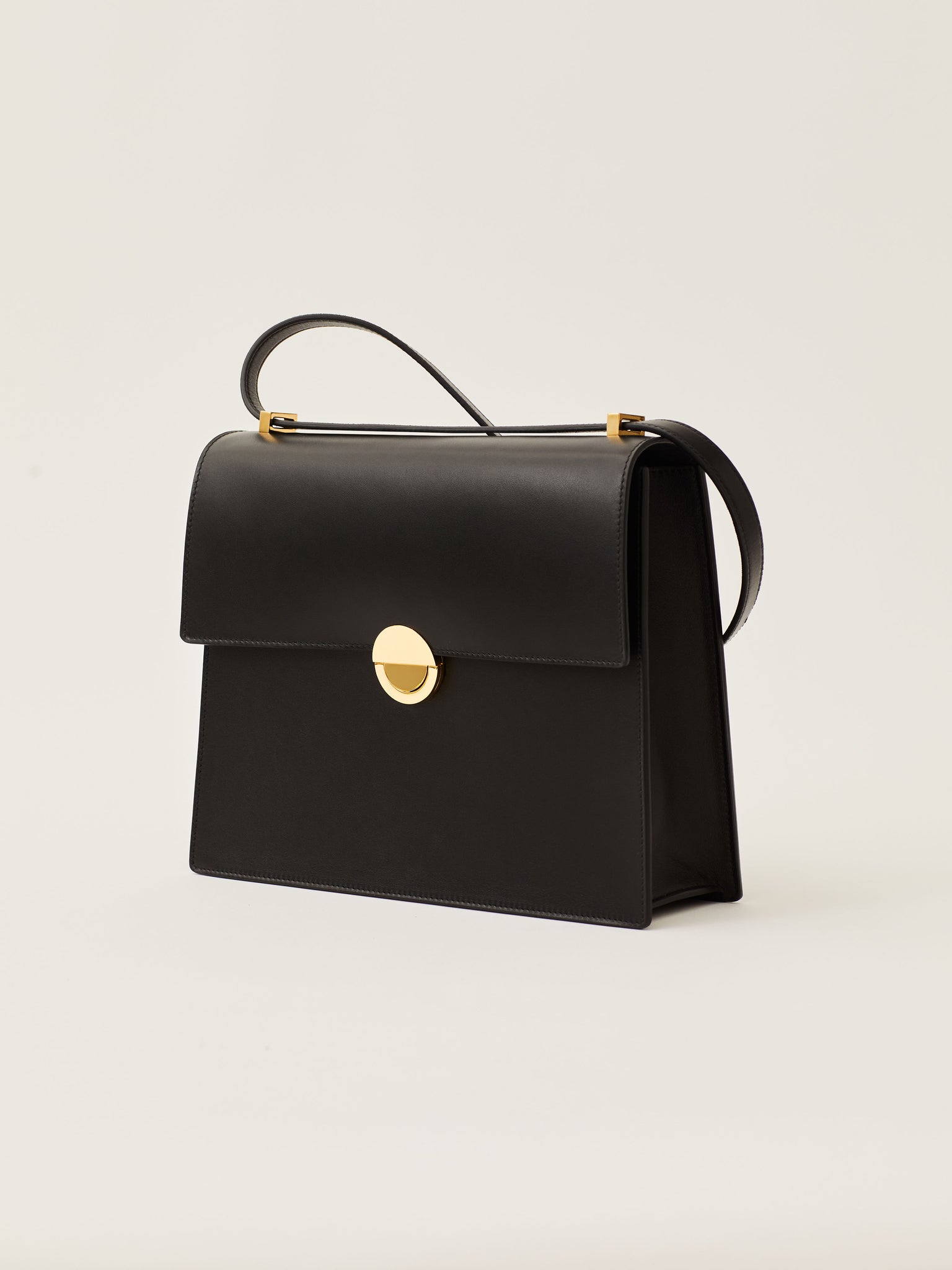 Objets Daso Black Leather Hye Handbag: Profile View with Draped Shoulder Strap